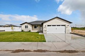 Twin Falls house for rent - A house with a white garage door and a black roof.