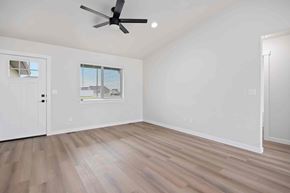 Twin Falls house for rent - A room with a ceiling fan and a window with blinds.