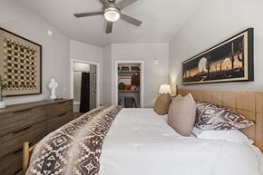 Phoenix apartment for rent - A bedroom with a large bed and a ceiling fan.