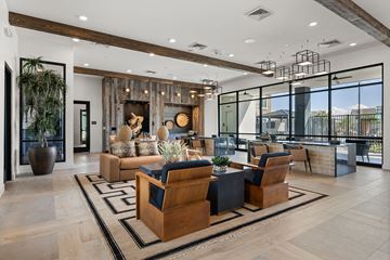 Phoenix apartment for rent - A modern living room with a large wooden coffee table and a fireplace.