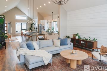 Bozeman house for rent - A living room with a grey couch and a wooden coffee table.