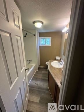 Inverness apartment for rent - A bathroom with a white door and a brown wall.