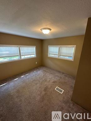 Inverness apartment for rent - A carpeted room with a window and a light on the ceiling.