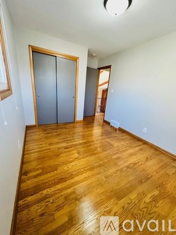 Neenah house for rent - A kitchen with wooden cabinets and a stove top oven.