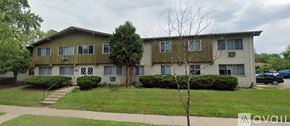 Madison apartment for rent - A two-story apartment building with a green lawn in front.