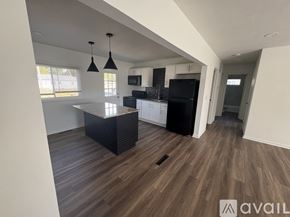 Johnstown apartment for rent - A kitchen with a black countertop and a black fridge.