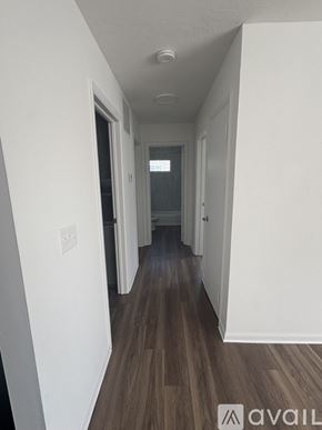 Johnstown apartment for rent - A long hallway with wood floors and white walls.