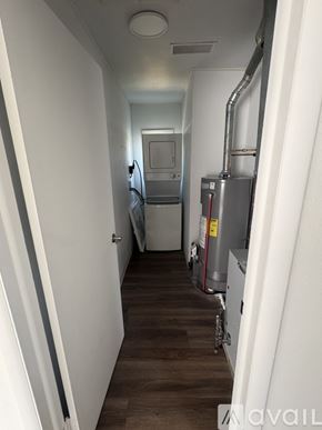 Johnstown apartment for rent - A narrow hallway with a refrigerator and a furnace.