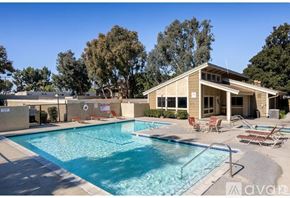 Azusa apartment for rent - A large outdoor swimming pool with a house in the background.