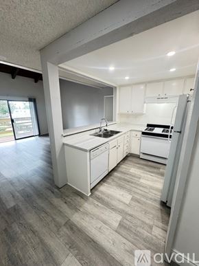 Azusa apartment for rent - A kitchen with a stove, sink, and refrigerator.