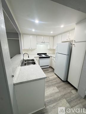 Azusa apartment for rent - A room with a bed in the foreground and a sliding door leading to a balcony.