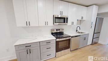 Washington apartment for rent - A kitchen with white cabinets and stainless steel appliances is available for rent.