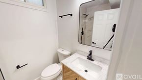 Washington apartment for rent - A white toilet sits next to a sink in a small bathroom.