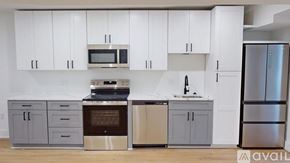 Washington apartment for rent - A kitchen with white cabinets and a variety of appliances.