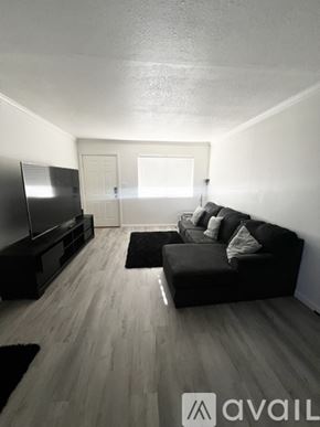 Phoenix apartment for rent - A pool surrounded by a black fence with palm trees in the background.