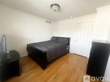 Phoenix apartment for rent - A living room with a black couch and a television.