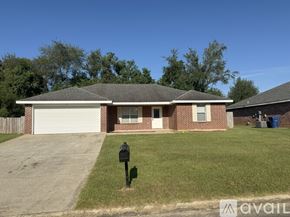 Deridder house for rent - A house with a grey roof and a white garage door.