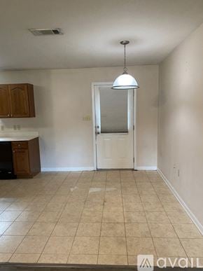 Deridder house for rent - A room with a white door and a brown cabinet.