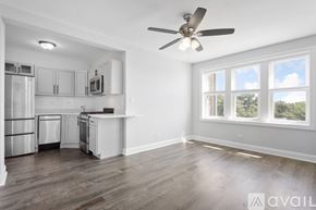 Chicago apartment for rent - A spacious kitchen with a refrigerator, microwave, and oven.