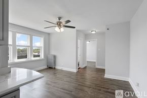 Chicago apartment for rent - A spacious room with a ceiling fan and a window overlooking the outdoors.