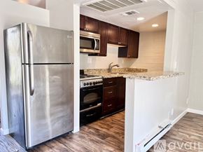 Phoenix apartment for rent - A kitchen with a stainless steel refrigerator and microwave.