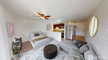 Phoenix apartment for rent - A living room with a white couch and a round ottoman.