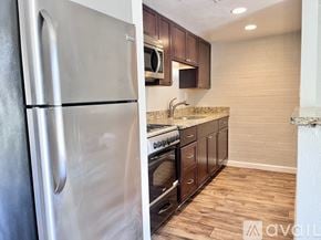 Phoenix apartment for rent - A kitchen with a stainless steel refrigerator and wooden cabinets.
