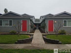 Fullerton apartment for rent - A row of houses with red doors in the front yard.