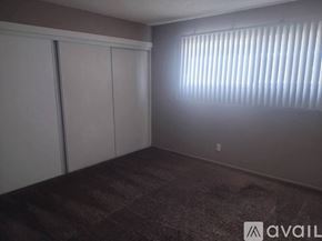 Fullerton apartment for rent - A room with a carpeted floor and a window with blinds.