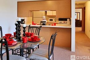 Tecumseh apartment for rent - A modern kitchen with a glass table set for two.