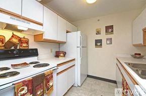 Tecumseh apartment for rent - A kitchen with a stove, refrigerator, and oven.