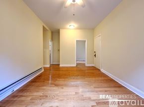 Chicago apartment for rent - A long hallway with wood floors and white walls.