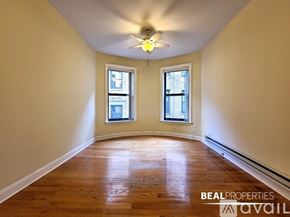 Chicago apartment for rent - A room with wooden floors and two windows is available for rent.