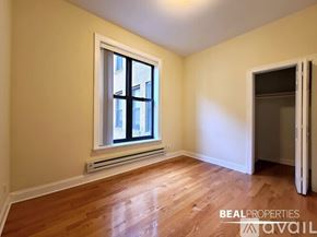 Chicago apartment for rent - A room with a window and wooden floors is available for rent.