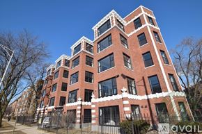 Chicago apartment for rent - A tall red brick building with white trim and windows.