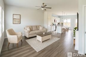 Summerville house for rent - A living room with a beige sofa, a chair, and a coffee table.