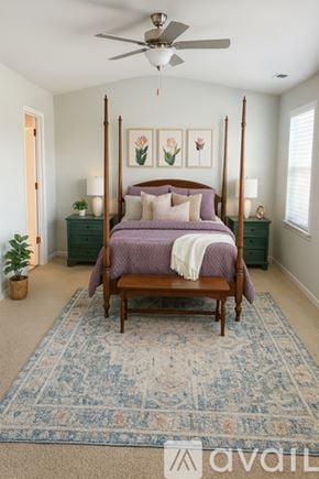 Summerville house for rent - A bedroom with a four poster bed and a rug on the floor.