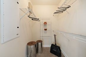 Miami Lakes apartment for rent - a spacious closet with shelves and a suitcase and a guitar