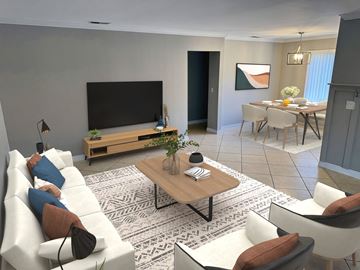 Glendale apartment for rent - A modern living room with a white sofa, a wooden coffee table, and a television on a wooden stand.