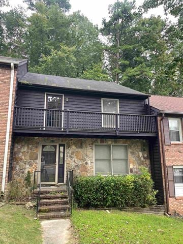 Birmingham house for rent - A house with a black front and a stone wall.