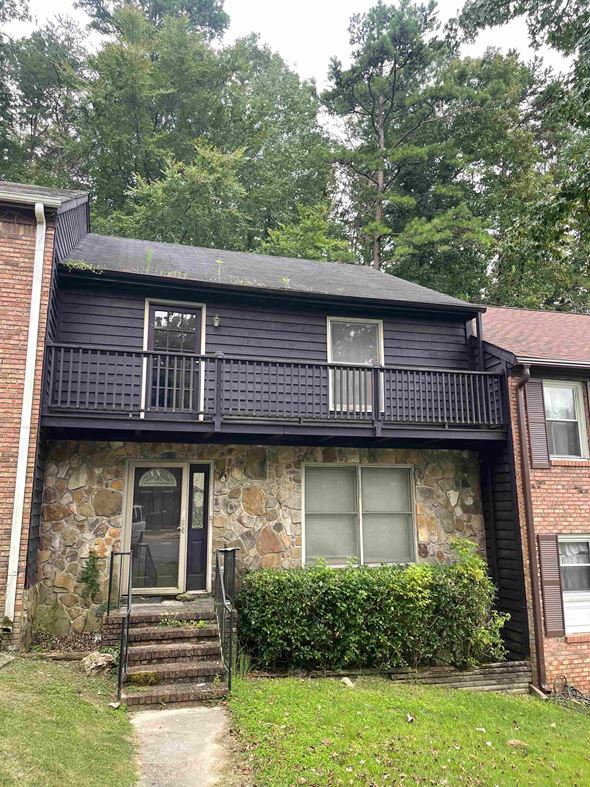 Birmingham house for rent - A house with a black front and a stone wall.