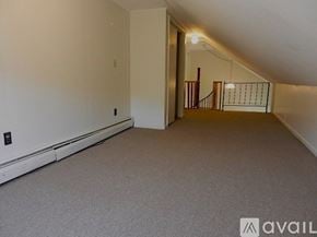 Poultney apartment for rent - A spacious room with a staircase leading to another level.