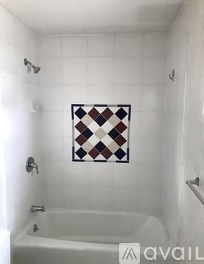 Poultney apartment for rent - A white bathroom with a white tub and a white shower.