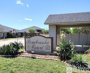 Gatesville apartment for rent - A sign for Pembrooke Court is in front of a building.