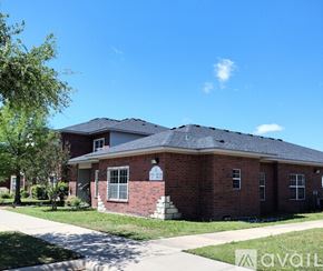 Gatesville apartment for rent - A red brick house with a white door and windows.