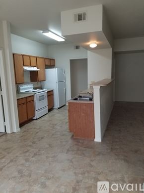 Gatesville apartment for rent - A kitchen with a refrigerator, sink, and cabinets.