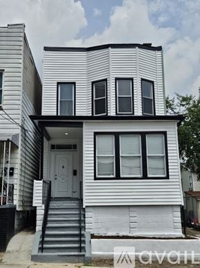 Jersey City apartment for rent - A white house with black trim and a grey roof.