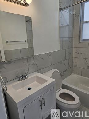 Jersey City apartment for rent - A bathroom with a sink, toilet, and bathtub.