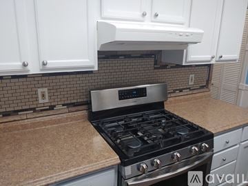 Anchorage house for rent - A modern kitchen with a black stove top oven.