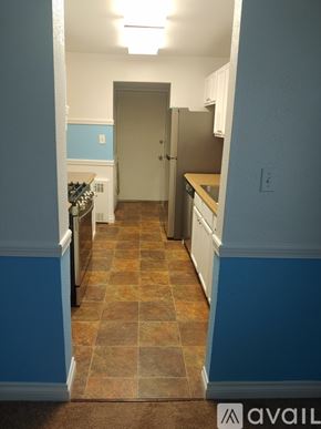 Anchorage house for rent - A kitchen with a tile floor and a refrigerator.